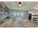 Living room with sectional sofa, coastal decor, and kitchen view at 1030 Tidewater Shores Loop # 306, Bradenton, FL 34208