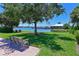 Serene waterfront view with lush landscaping and bench at 1030 Tidewater Shores Loop # 306, Bradenton, FL 34208