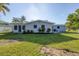 House with grassy backyard and lush landscaping at 104 24Th Ne St, Bradenton, FL 34208