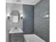 Clean bathroom with gray tile and bathtub at 104 24Th Ne St, Bradenton, FL 34208