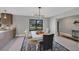 Open concept dining room with large window and modern chandelier at 104 24Th Ne St, Bradenton, FL 34208
