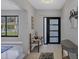 Bright entryway with tile flooring, bench, and console table at 104 24Th Ne St, Bradenton, FL 34208