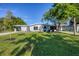 Single-story home with updated exterior, featuring a modern facade and a well-maintained lawn at 104 24Th Ne St, Bradenton, FL 34208