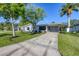 Recently updated single-story home showcasing a modern exterior and a spacious front yard at 104 24Th Ne St, Bradenton, FL 34208
