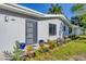 Modern home with gray exterior, landscaping, and stylish front door at 104 24Th Ne St, Bradenton, FL 34208
