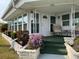 Covered porch with seating area and landscaping at 1111 42Nd E Ave, Ellenton, FL 34222