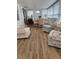 Relaxing sunroom featuring wicker furniture and wood floors at 1111 42Nd E Ave, Ellenton, FL 34222