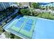 Aerial view of community tennis courts with surrounding buildings visible at 1111 N Gulfstream Ave # 4E, Sarasota, FL 34236