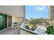 Balcony featuring a table and chairs, with views of lush greenery, city buildings, and vibrant scenery at 1111 N Gulfstream Ave # 4E, Sarasota, FL 34236