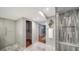 Large bathroom featuring marble flooring, a glass shower, and well-organized storage at 1111 N Gulfstream Ave # 4E, Sarasota, FL 34236