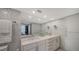 Bathroom showcasing a double sink vanity, patterned accent wall, marble floors, and modern fixtures at 1111 N Gulfstream Ave # 4E, Sarasota, FL 34236