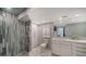 Modern bathroom showcasing marble floors, stylish tiling, a glass-enclosed shower, and a vanity with plenty of storage at 1111 N Gulfstream Ave # 4E, Sarasota, FL 34236