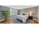 Modern bedroom features a large window, patterned accent wall, hardwood floors, and stylish decor at 1111 N Gulfstream Ave # 4E, Sarasota, FL 34236