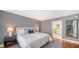 Comfortable bedroom with a geometric patterned wall and seamless access to an ensuite bathroom at 1111 N Gulfstream Ave # 4E, Sarasota, FL 34236