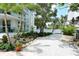 Relaxing courtyard with a gravel path, bench, tropical landscaping, and building in background at 1111 N Gulfstream Ave # 4E, Sarasota, FL 34236