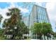 Modern high rise building with lush landscaping and palm trees at 1111 N Gulfstream Ave # 4E, Sarasota, FL 34236