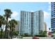 Exterior of a modern high-rise building with palm trees at 1111 N Gulfstream Ave # 4E, Sarasota, FL 34236