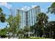 Towering condo building with balconies and lush landscaping at 1111 N Gulfstream Ave # 4E, Sarasota, FL 34236