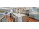 Spacious open floor plan with a kitchen featuring stainless appliances and breakfast bar seating at 1111 N Gulfstream Ave # 4E, Sarasota, FL 34236