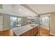 Bright, open kitchen with a granite countertop island, stainless steel appliances, and seamless access to an outdoor balcony at 1111 N Gulfstream Ave # 4E, Sarasota, FL 34236