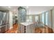 Open concept kitchen with stainless steel appliances, marble countertops and view to the balcony at 1111 N Gulfstream Ave # 4E, Sarasota, FL 34236