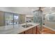 Bright kitchen featuring a stainless steel sink, custom cabinets, and access to the living area at 1111 N Gulfstream Ave # 4E, Sarasota, FL 34236