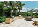 Two built-in grills, stone facade, and patio furniture in a landscaped courtyard at 1111 N Gulfstream Ave # 4E, Sarasota, FL 34236