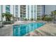 Relaxing community pool area with plenty of lounge chairs and patio furniture at 1111 N Gulfstream Ave # 4E, Sarasota, FL 34236