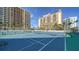 Two well-maintained tennis courts with surrounding buildings at 1111 N Gulfstream Ave # 4E, Sarasota, FL 34236