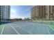 Two tennis courts nestled between residential buildings at 1111 N Gulfstream Ave # 4E, Sarasota, FL 34236