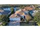 Aerial view of a single-Gathering home with a three-car garage and a lake view at 12031 Longview Lake Cir, Bradenton, FL 34211