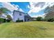 Large backyard with grassy lawn and home view at 12031 Longview Lake Cir, Bradenton, FL 34211