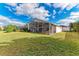 Large backyard with grassy lawn and screened patio at 12031 Longview Lake Cir, Bradenton, FL 34211