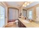Bathroom with striped shower curtain and granite countertop at 12031 Longview Lake Cir, Bradenton, FL 34211