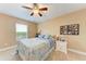 Spacious bedroom with ceiling fan and window at 12031 Longview Lake Cir, Bradenton, FL 34211