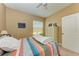Cozy bedroom with striped bedding and ample closet space at 12031 Longview Lake Cir, Bradenton, FL 34211