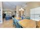 Charming dining area with a light wood table and blue chairs, open to kitchen at 12031 Longview Lake Cir, Bradenton, FL 34211