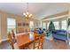 Bright dining room with hardwood floors and wooden table for six at 12031 Longview Lake Cir, Bradenton, FL 34211