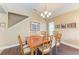 Dining room with hardwood floors and a wooden table for six at 12031 Longview Lake Cir, Bradenton, FL 34211