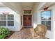 Inviting front entrance with double doors and a charming wicker chair at 12031 Longview Lake Cir, Bradenton, FL 34211