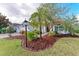 Landscaped front yard with mature trees and lighting at 12031 Longview Lake Cir, Bradenton, FL 34211