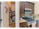Well-organized pantry and kitchen with gas range and microwave at 12031 Longview Lake Cir, Bradenton, FL 34211