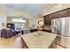 Open kitchen features granite island, stainless steel appliances, and views to Gathering room at 12031 Longview Lake Cir, Bradenton, FL 34211