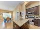 Kitchen features granite countertops, dark wood cabinets, and an island at 12031 Longview Lake Cir, Bradenton, FL 34211