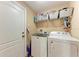 Bright laundry room with washer, dryer, and overhead shelving at 12031 Longview Lake Cir, Bradenton, FL 34211