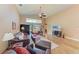 Spacious living room with vaulted ceilings, leather furniture and view of backyard at 12031 Longview Lake Cir, Bradenton, FL 34211