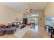 Spacious living room with vaulted ceilings, leather furniture and view of backyard at 12031 Longview Lake Cir, Bradenton, FL 34211