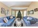 Cozy living room with hardwood floors, and blue plaid sofas around a coffee table at 12031 Longview Lake Cir, Bradenton, FL 34211