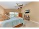 Main bedroom with vaulted ceilings, ceiling fan, and large window at 12031 Longview Lake Cir, Bradenton, FL 34211