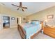 Main bedroom with large bed, ensuite access, and home office at 12031 Longview Lake Cir, Bradenton, FL 34211